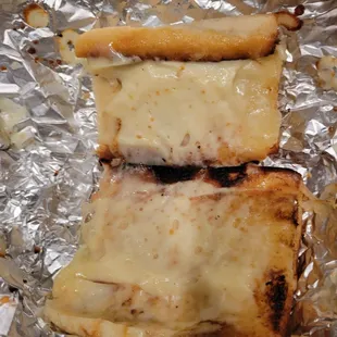 Partially burnt but very dry cheesy bread. They also cost $9 loaf....