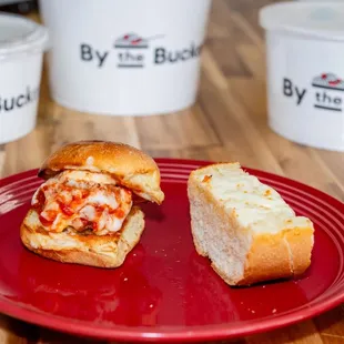 a red plate with a sandwich on it