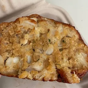 a person holding a piece of bread