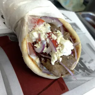 GYRO
made with :
Tzatziki sauce 
Tomato 
Red onion 
Feta cheese 
And beef/lamb Halal meat