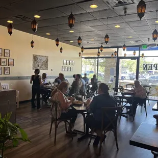 people sitting at tables in a restaurant