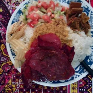 Made this at home. Spiced, cured, beef slices, lentil soup over white rice, pickled mangoes, fresh salad, some chips. Great selection