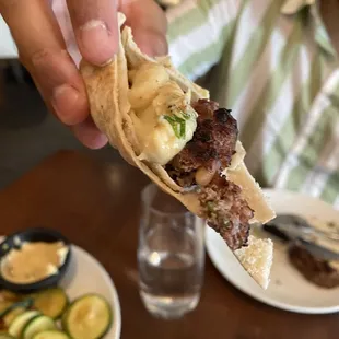 a person holding a piece of food