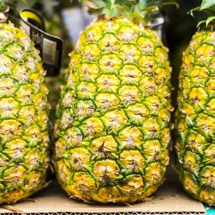 three pineapples on display