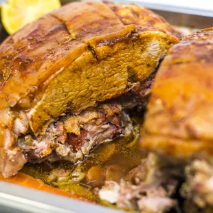 a roasting dish with meat and vegetables