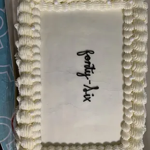 a square cake with white frosting