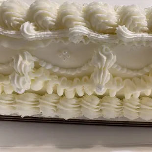 a cake with white frosting