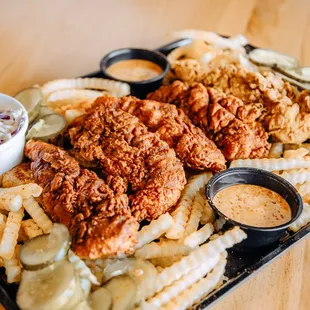 a platter of fried chicken, fries, coleslaw, coleslaw, coleslaw