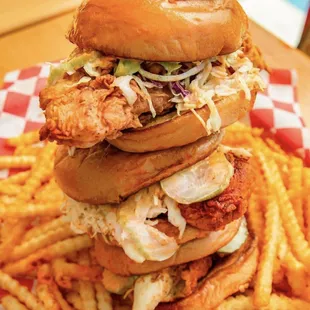 a stack of chicken sandwiches and french fries