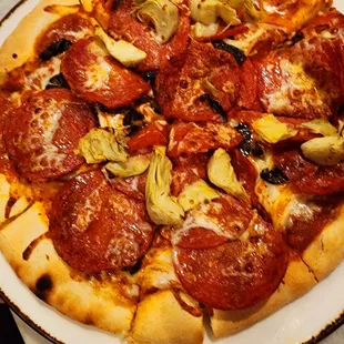 a pepperoni and artichoke pizza