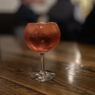 a glass of wine on a table