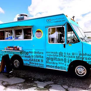 a blue food truck parked in a parking lot