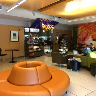 people sitting at tables in a library