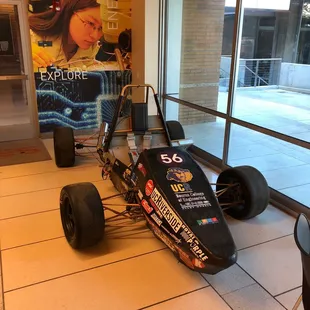 a race car in the lobby of a building
