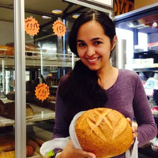 a woman holding a loaf of bread