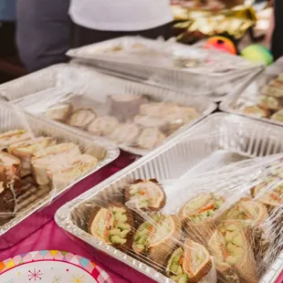 a variety of sandwiches in plastic containers
