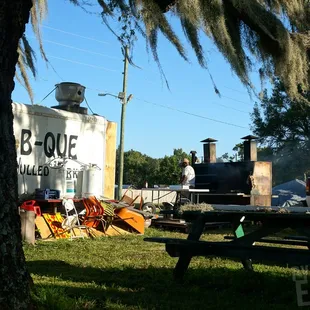 (behind the food truck) there&apos;s a few picnic tables. You also have a good view of the smoker