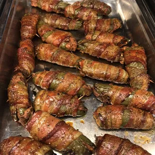 Brisket and cream cheese stuffed jalapeño poppers wrapped in bacon.