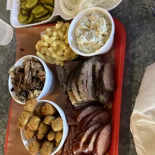 Half lb of each - brisket, sausages, pulled pork Sides - Potato salad, fried okra, mac &amp; cheese