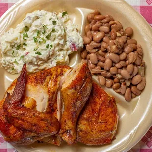 Chicken plate with potato salad and pinto beans.