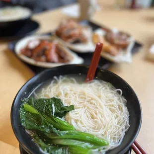 a bowl of noodles and broccoli