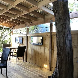 a table and chairs under a tree