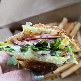 Pork loin croissant with an egg over easy onions garlic aioli and fresh arugula!