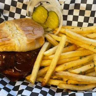 a pulled pork sandwich and french fries