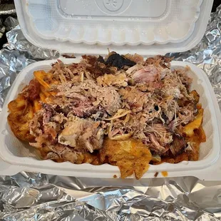 Big Ass Pulled Pork over waffle fries without added seasoning and sauce on the side