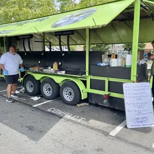 two men standing in front of a food truck