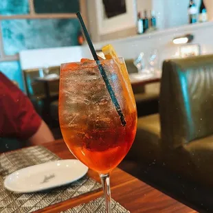 a glass of cocktail on a table