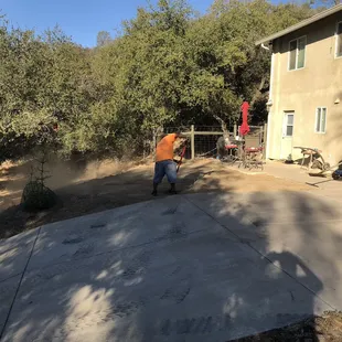 two men working on a concrete driveway