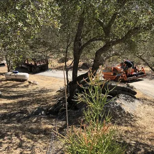 an orange tractor parked on a dirt road