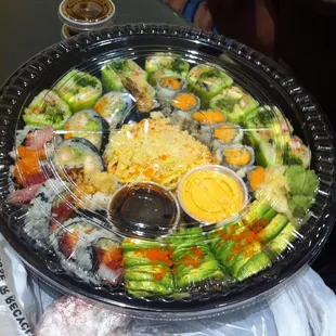 a plate of sushi and vegetables