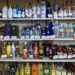 Liquor with hand written price tags on torn paper, love it