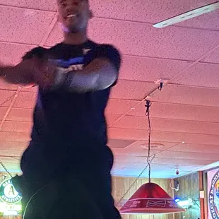 Jumping on tables and dancing his ass off.