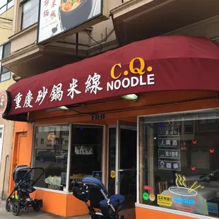 Outside of C.Q. Noodles. Strollers parked by customers taking out.