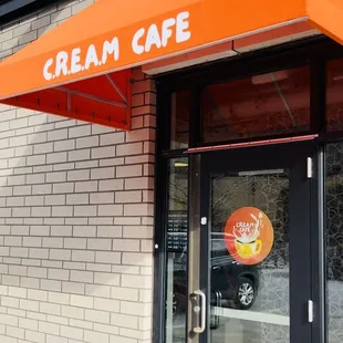 ows an orange awning on a brick building