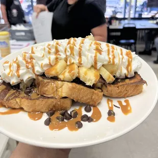 dulce de leche french toast topped with banana and chocolate chips