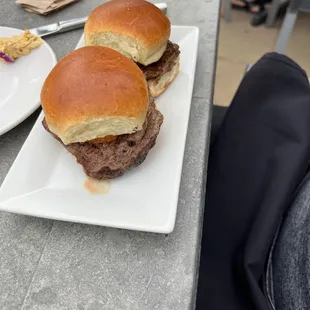 two burgers on a white plate