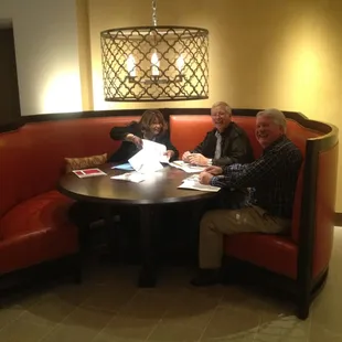 a group of people sitting around a table