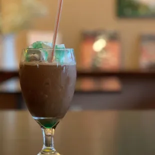 a drink in a glass on a table