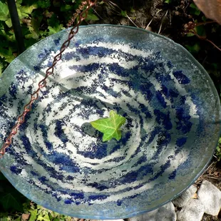 Green Glass Swan Designs using recycled glass to make functional art such as this bird bath/feeder.