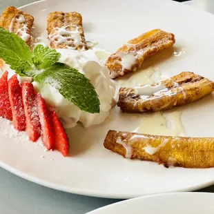 Plata no Macho Frito (fried plantains drizzled with condensed milk and whipped cream for dipping on the side. It&apos;s YUMMY!