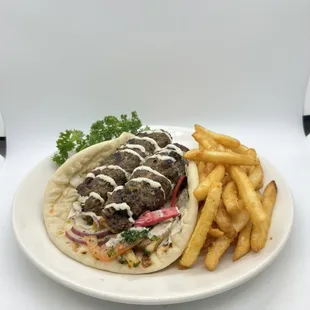 Beef kofta sandwich- ground beef, Herb and spices, pickled veggies, marinated onion, tomato &amp; tahini dressings in pita bread