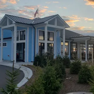 a car parked in front of a blue building