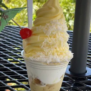 Pineapple Dole sundae.  Pineapple dole whip  Toasted coconut  Cake