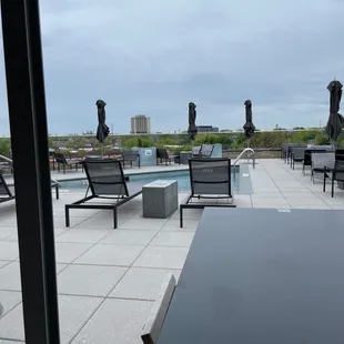 lounge chairs and tables on a rooftop