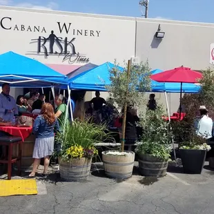 a group of people standing under umbrellas