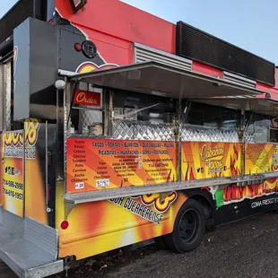 a man standing in front of a food truck
